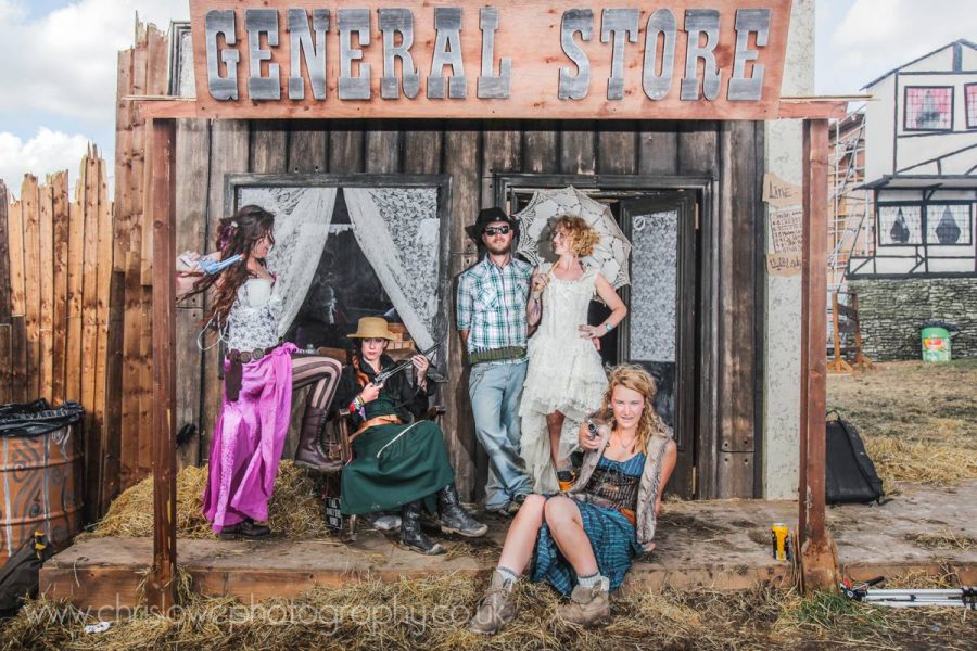 Boomtown photo - A group of festival goers outside the old west general store