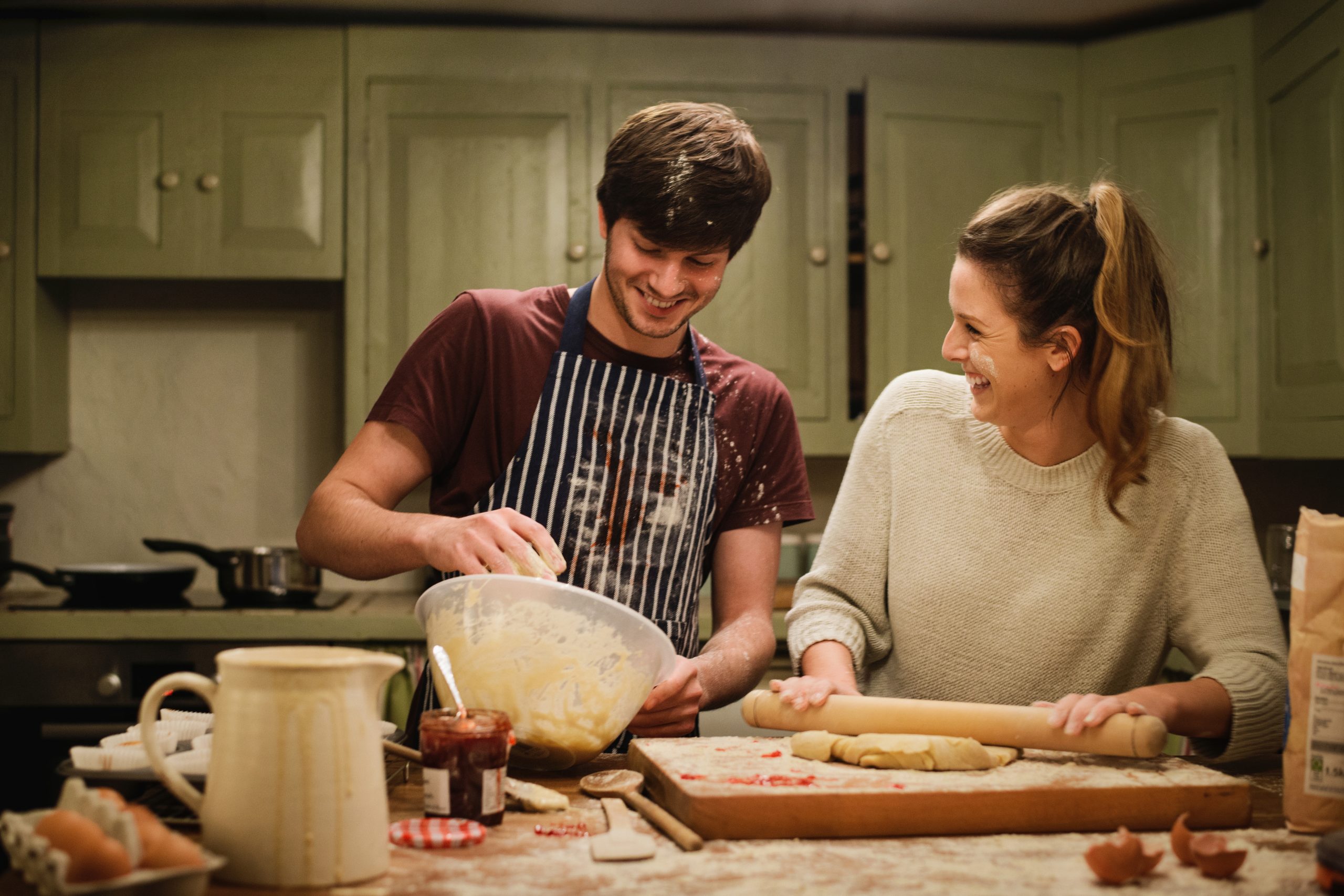 One of the most complex but engaging types of product photography, lifestyle mashes together creative still life and model photography. In this example, a young couple are laughing while cooking. The woman has batter on her face, and the man's apron is covered in cake mix.